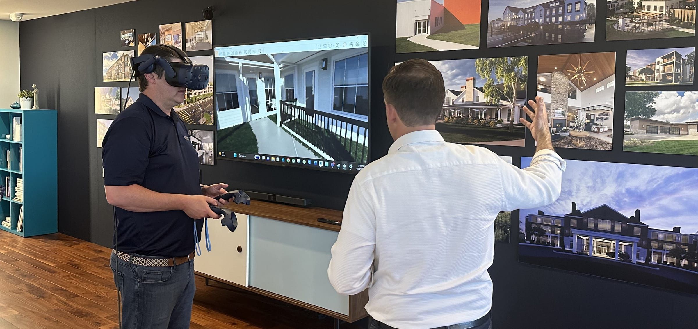 A client team member in a VR headset walks through a senior living design while a colleague gestures toward the project renderings on the wall.